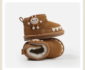 Warm toddler snow boots featuring a cute cartoon monster design and thick white plush lining