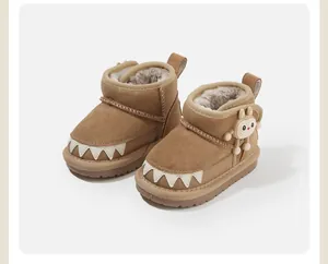 Detail view of brown toddler snow boots featuring soft plush lining and cute cartoon charm
