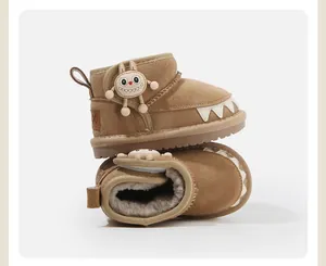 Cozy brown toddler snow boots with monster detail and warm faux fur lining.