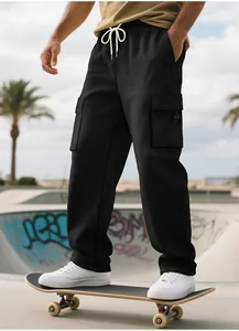 Men's heavy black loose cargo sweatpants shown while skateboarding in an outdoor park