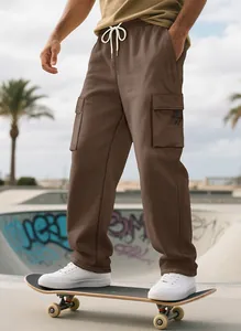 Detailed view of brown cargo sweatpants featuring large side pockets and drawstring waist