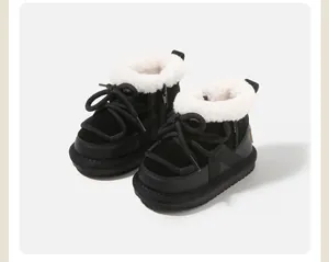 Cozy black children's snow boots featuring thick laces and soft white fleece lining