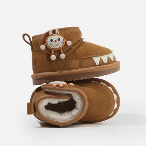 Warm brown toddler snow boots with cute cartoon monster charm and soft plush lining