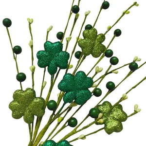Close-up of glittery green shamrock stems and berries for St. Patrick's Day decor.