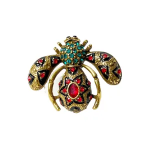 Vintage enamel bee brooch with red and teal rhinestones on antique gold base decoration