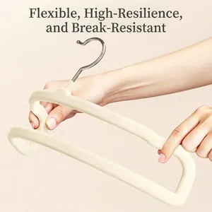 Flexible non-slip beige flocked pants hanger featuring a space-saving square design