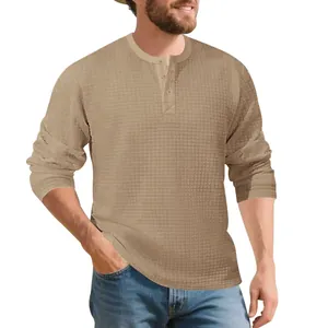 Men's waffle knit Henley long sleeve shirt in vintage khaki with button neck detail.