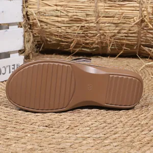 Detailed view of brown platform clog sole with size 37 marking and anti-slip texture