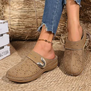 Close-up of retro French style floral mules on model with rustic straw background