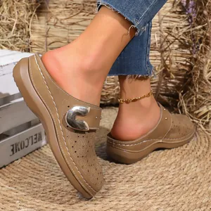 Women's French retro platform mules with floral perforated patterns in a rustic setting