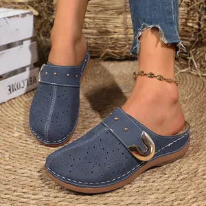 Vintage French blue platform clogs for women with floral cutouts and gold buckle
