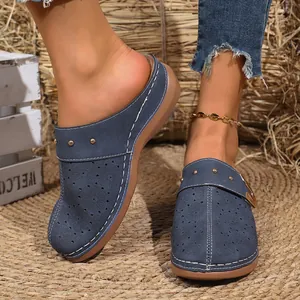 Detail view of stylish blue floral perforated mules with retro thick sole for women
