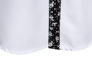 Close-up detail showing white stitching and floral trim on men's fashion casual shirt