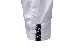 Detailed macro view of white shirt cuff with stylish black floral pattern trim.