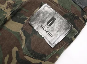Close-up detail of camouflage cargo jeans with stitching and vintage L-SKYB brand tag.