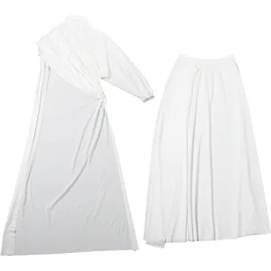 Detail view of white high-neck pleated top and high-slit long skirt set