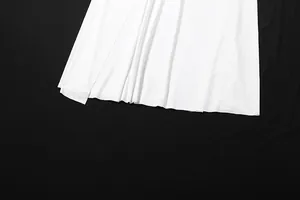 Close-up macro view showing the elegant stitching of a white skirt's fine hem line
