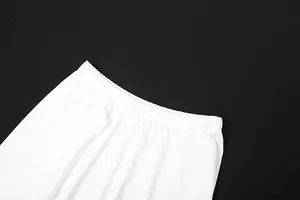Detailed macro shot of the high-elastic waistband on a elegant white pleated maxi skirt