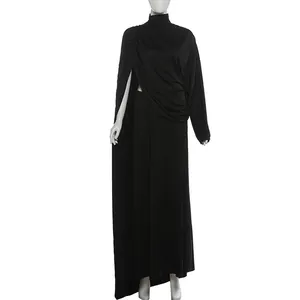 Detailed front view of black draped high-neck top and high slit skirt set on mannequin