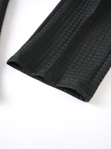 Detailed close-up view of the black waffle knit texture on these men's casual outdoor trousers.