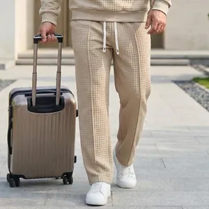 Close-up detail of waffle texture men's loose leisure pants featuring a drawstring waist