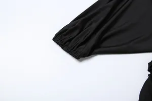 Detailed macro view of the elastic ruffled cuff on a black long-sleeved elegant top