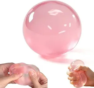 Pink translucent stress relief squishy toy ball shown being squeezed and stretched