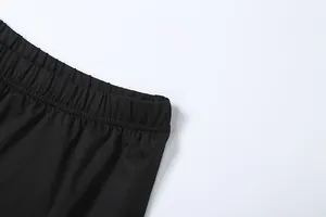 Close-up of the elastic waistband on a black high-slit skirt, showing pleated fabric texture.