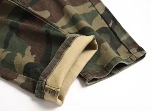 Macro detail of camouflage cargo pants leg opening showing durable stitching and texture
