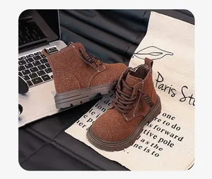 Detail of brown suede children's Martin boots with side zipper and stitching
