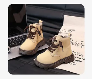 Side view of beige children's Martin boots with brown laces and durable side zipper detail.