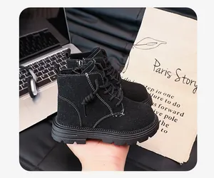 Close-up of black children's British style Martin boots with side zipper detail