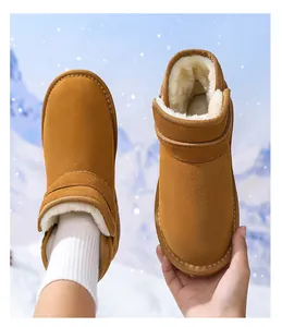 Close-up view of thick warm white faux fur lining inside children brown suede snow boots