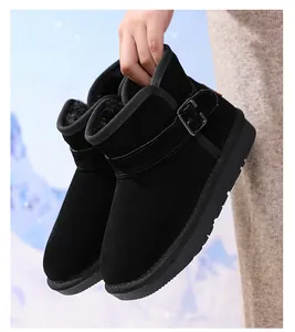 Detailed view of black children's leather snow boots with warm fleece lining and buckle.