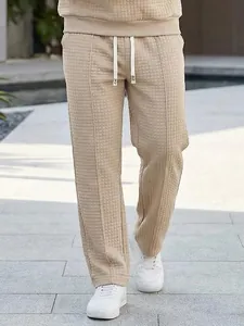Detail view of men's beige waffle knit casual trousers with drawstring waist