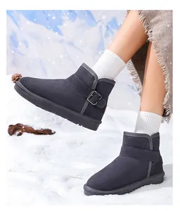 Children's dark grey leather snow boots with metal buckle detail worn in winter snow scene
