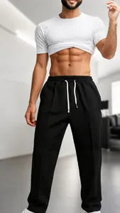 Close-up of black waffle knit men's casual pants with adjustable drawstring elastic waist