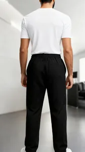 Detailed back view of men's black waffle-knit pants showing fit and texture quality.