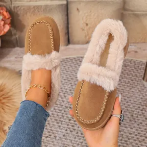 Close-up of warm winter suede slippers with plush faux fur trim and cozy lining detail.