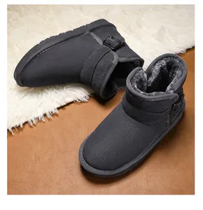 Close-up detail of grey children's snow boots with thick faux fur lining and buckle