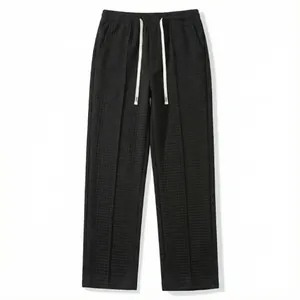 Detail shot of men's waffle knit casual pants showing elastic waist and texture.