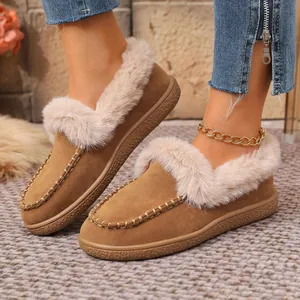 Macro detail view of women's cozy winter suede flat shoes with soft beige faux fur lining