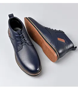 High-quality detail shot of navy blue leather men's boots featuring a non-slip gum rubber sole