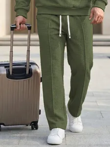 Stylish men's olive green waffle knit sweatpants with adjustable drawstring waist.
