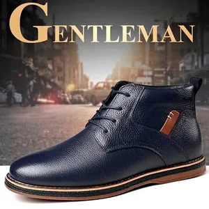 Stylish navy blue pebbled leather men's dress boots with lace-up design in city street.