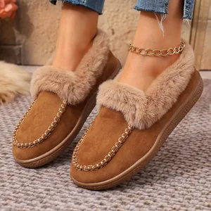 Close-up detail of women's brown suede winter loafers with plush faux fur trim