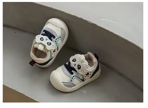 Detailed view of breathable toddler sneakers with cute panda face velcro straps