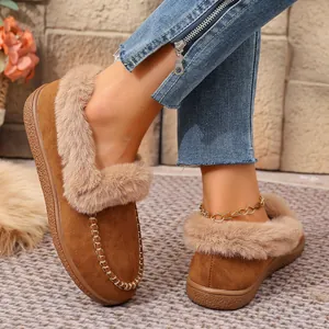 Close-up of brown suede loafers with cozy faux fur lining and braided stitching detail