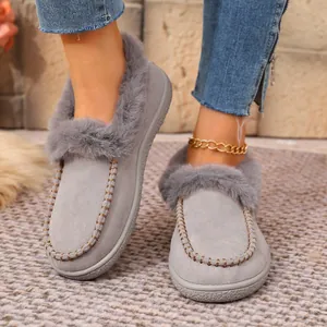 Detail of grey winter slippers with faux fur trim and warm plush lining
