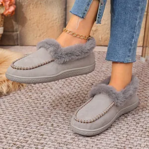 Close-up of grey suede winter slippers with faux fur lining and warm padding